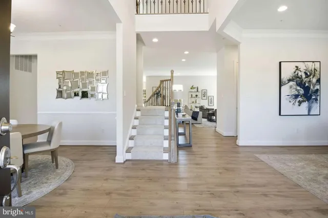 a view of a hallway with furniture and floor to ceiling window