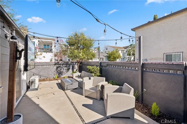 a building outdoor space with patio furniture and potted plants