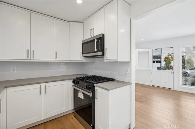 a view of a kitchen with electric appliances