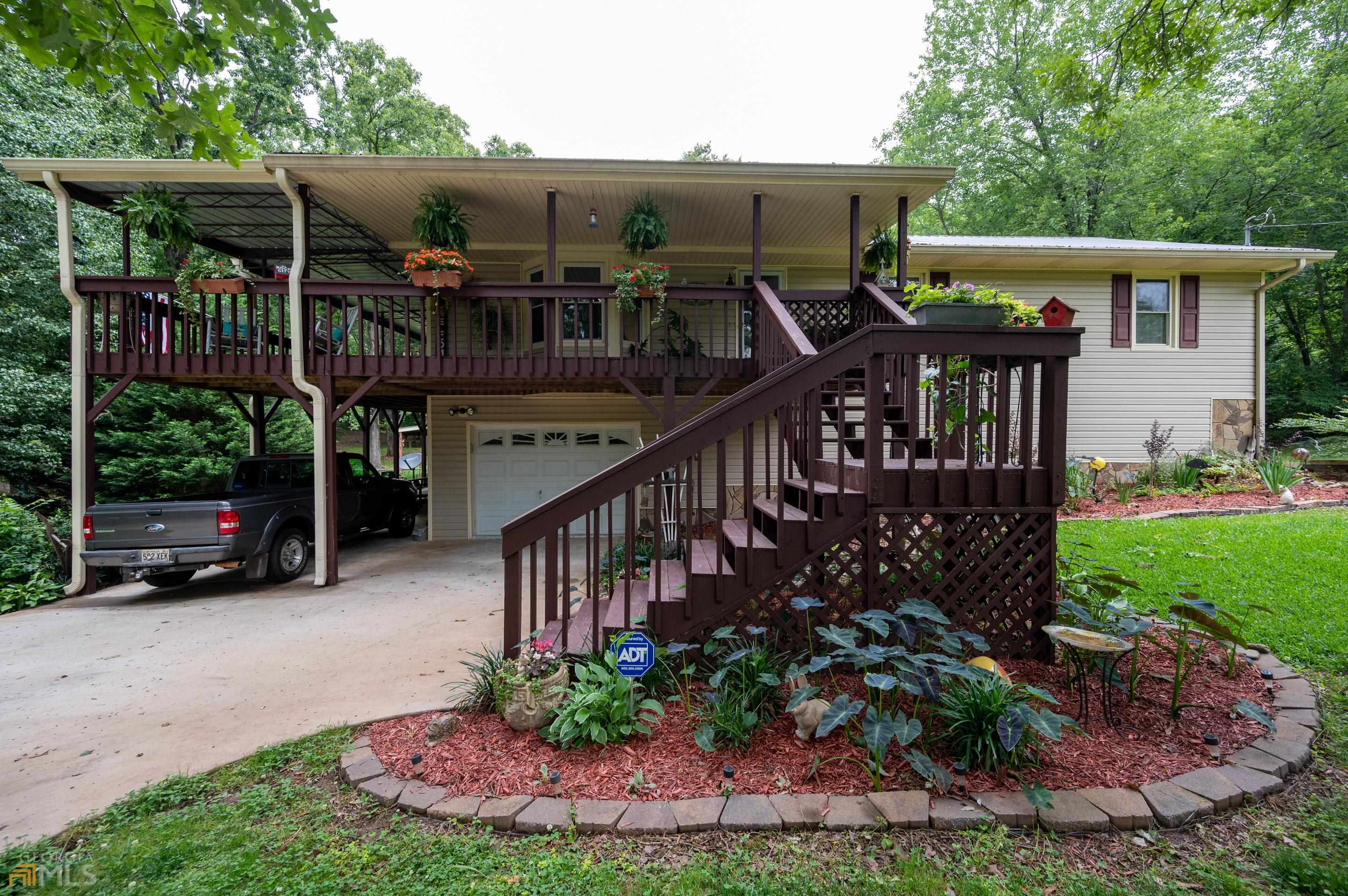 5723 Mt Zion Road Waco, GA 30182 - Photo 1 of 1 a view of house with outdoor seating and green space