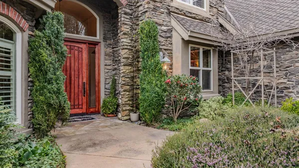 a view of a dining room with furniture a chandelier and wooden floor