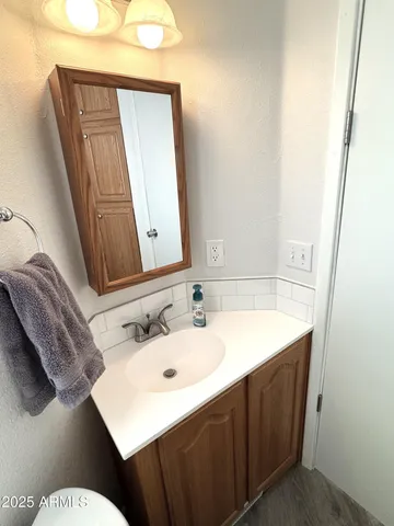 a bathroom with a sink and a mirror