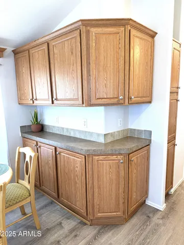 a kitchen with granite countertop a sink cabinets and wooden floor