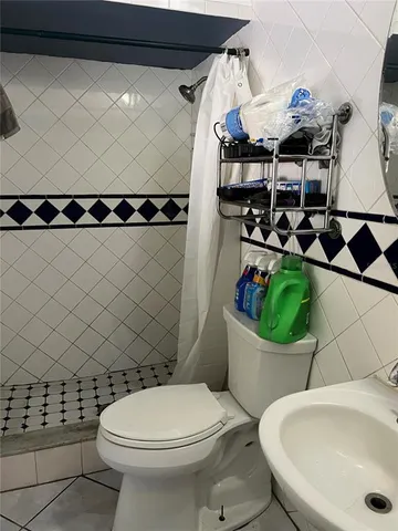 a bedroom with a bed and a tv