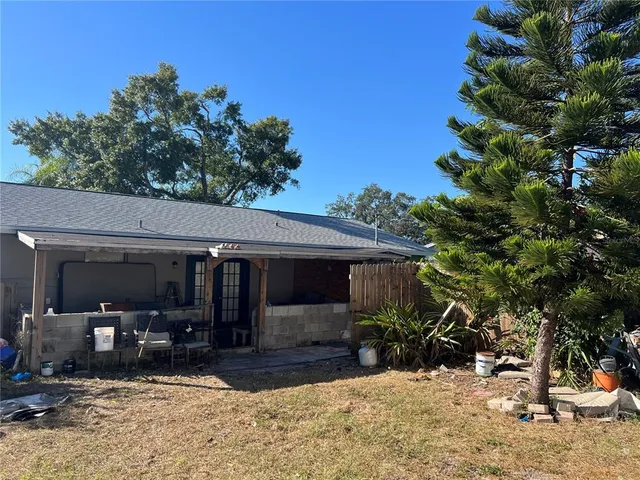 a view of a patio with table and chairs and potted plants