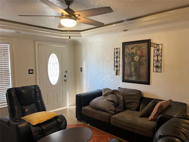 a living room with furniture and a mirror