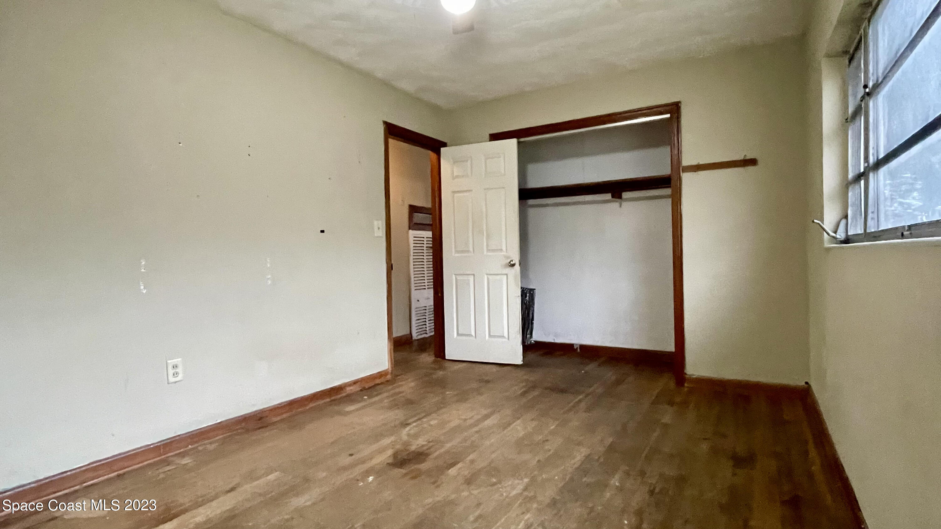 866 Sarno Road Melbourne, FL 32935 - Photo 13 of 19 a view of an empty room with wooden floor and closet
