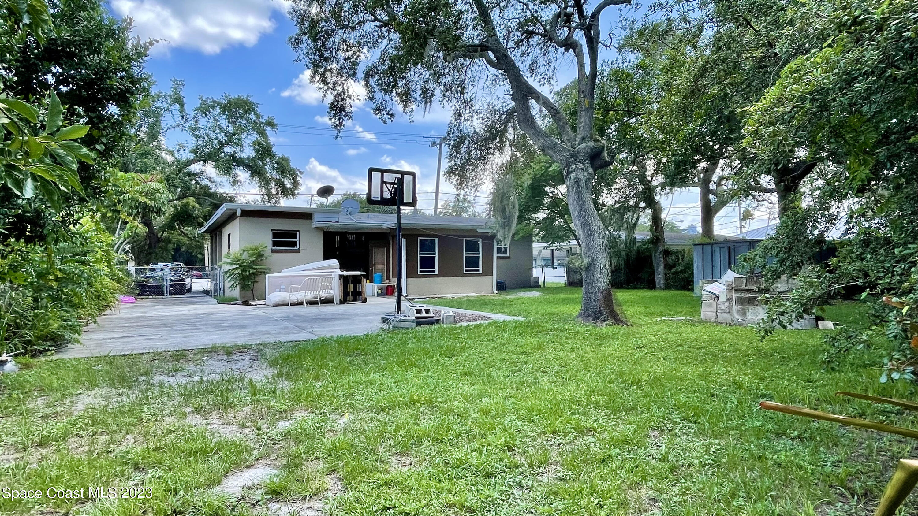 866 Sarno Road Melbourne, FL 32935 - Photo 17 of 19 a view of a house with a yard and sitting area
