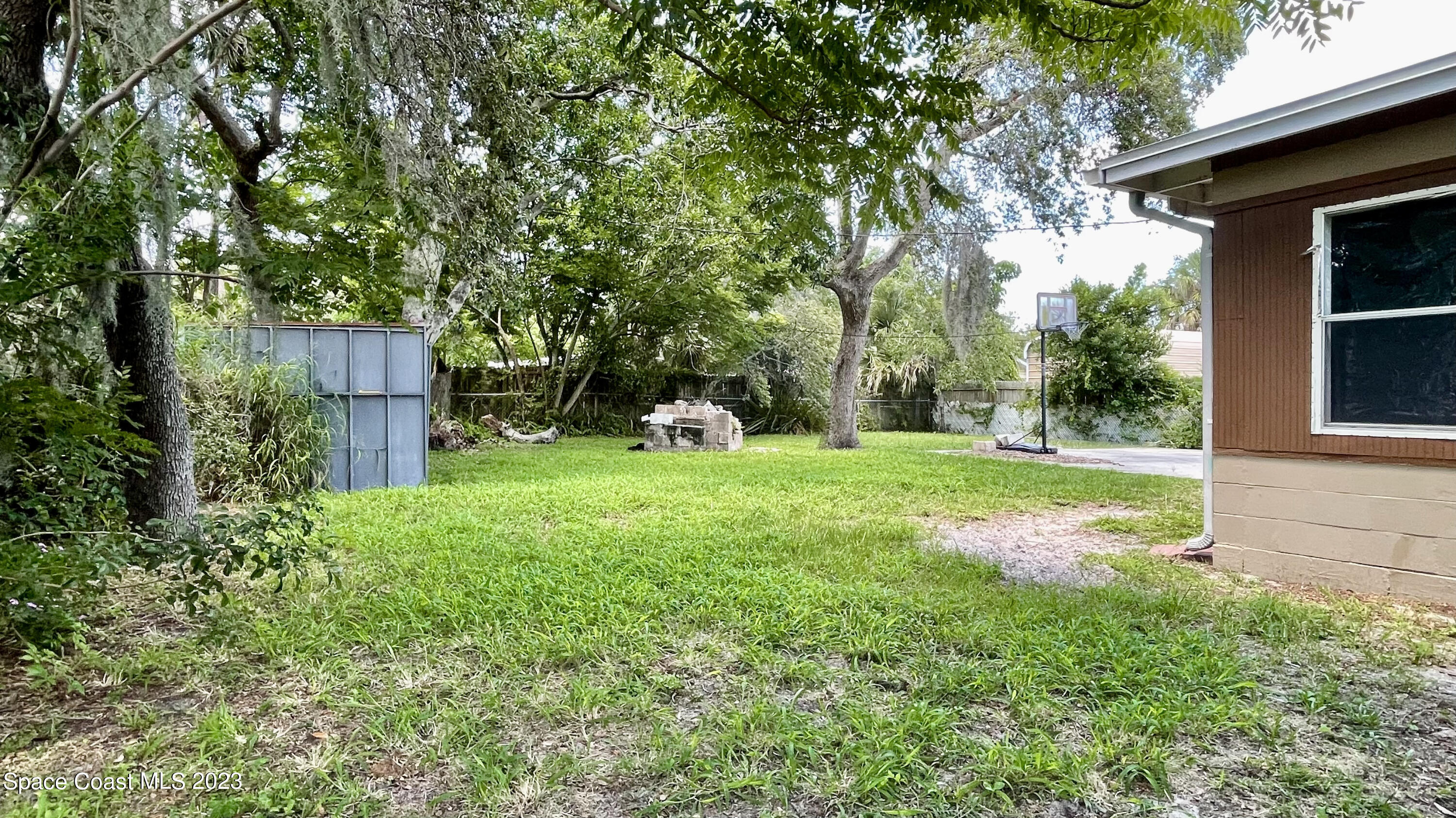 866 Sarno Road Melbourne, FL 32935 - Photo 18 of 19 a view of a house with backyard and a tree
