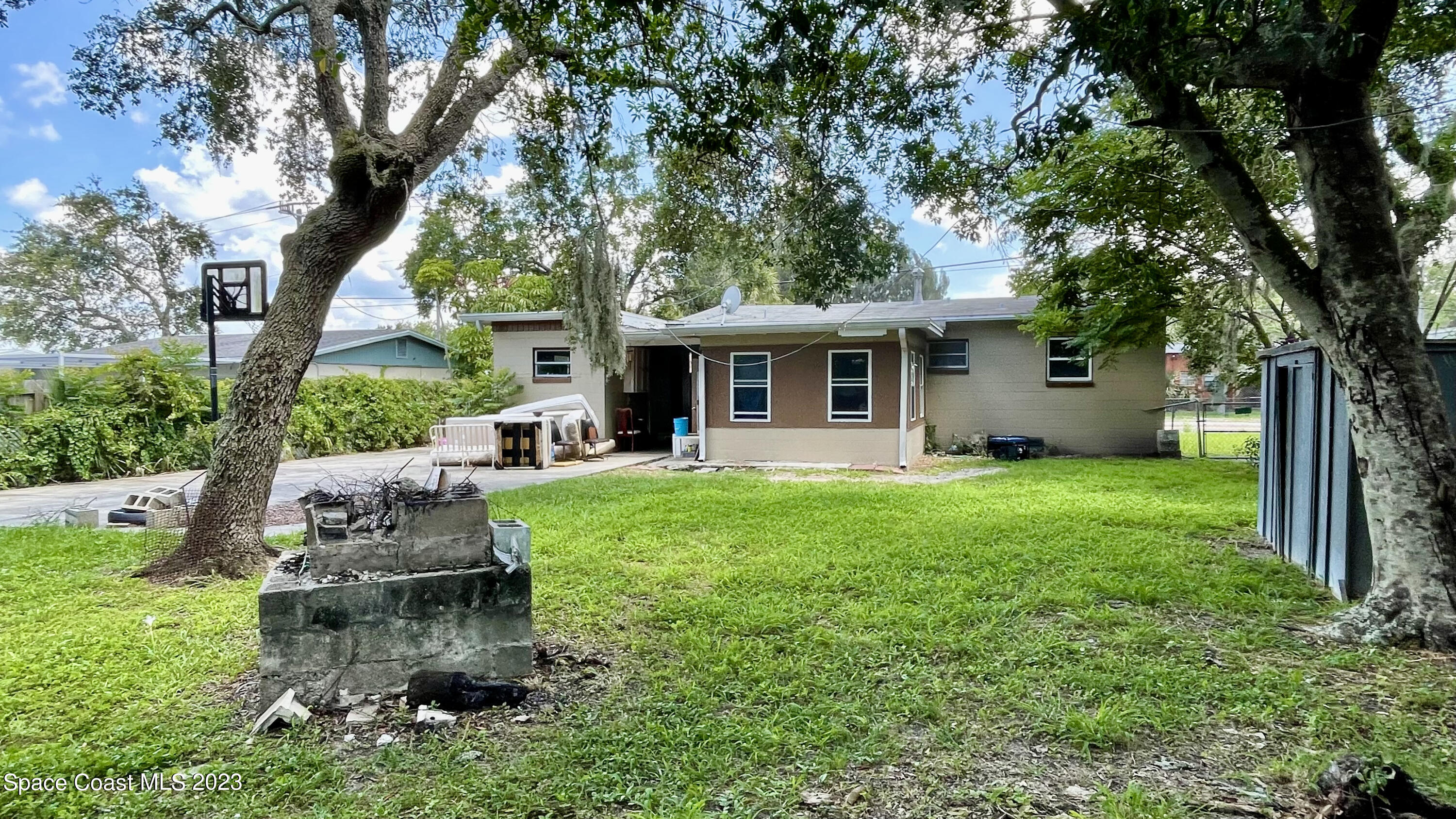 866 Sarno Road Melbourne, FL 32935 - Photo 19 of 19 a view of a house with backyard sitting area and garden