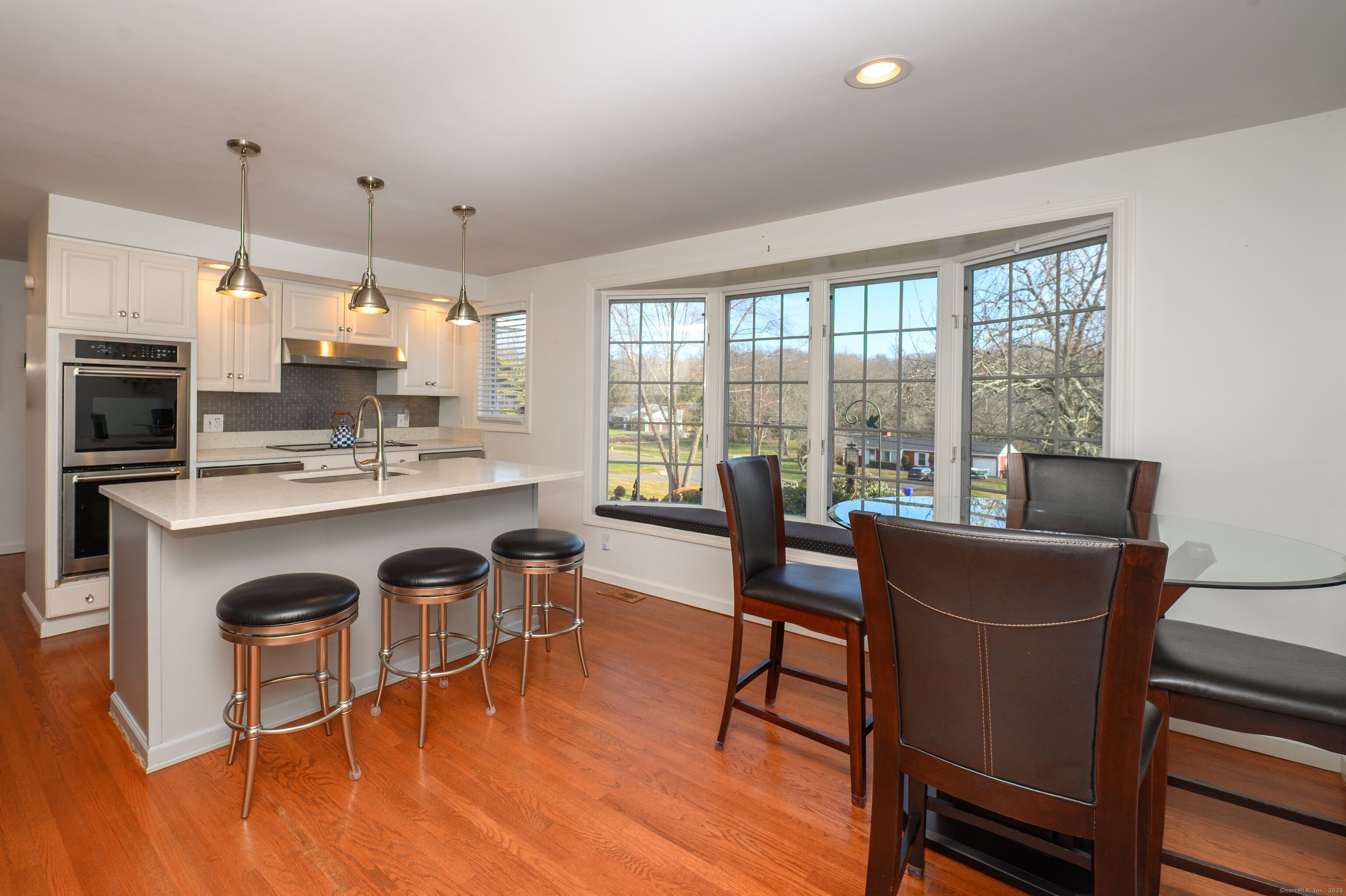 15 Griffing Pond Road Branford, CT 06405 - Photo 19 of 40 a dining room with furniture a chandelier and wooden floor