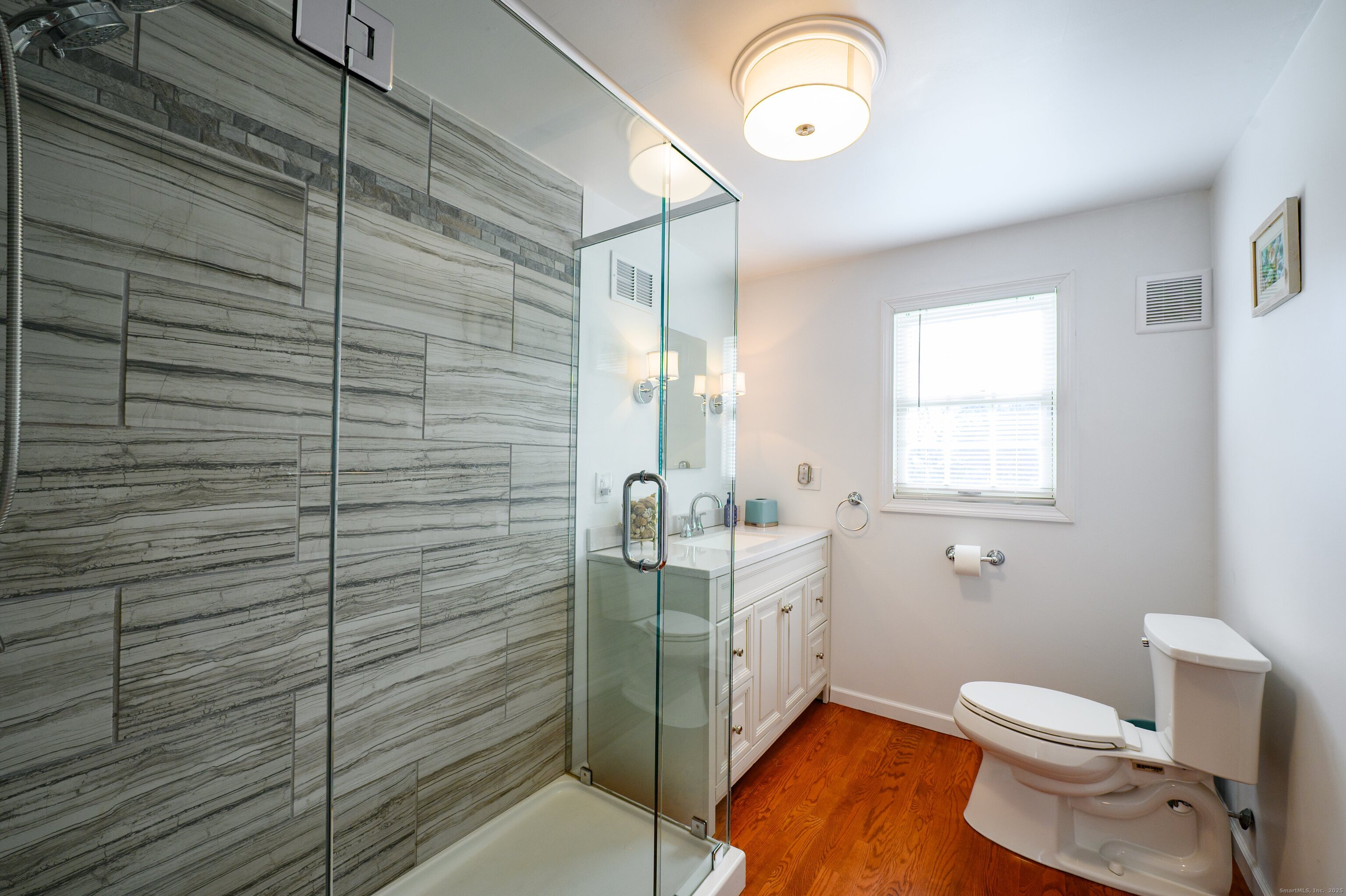 15 Griffing Pond Road Branford, CT 06405 - Photo 27 of 40 a bathroom with a toilet sink and mirror
