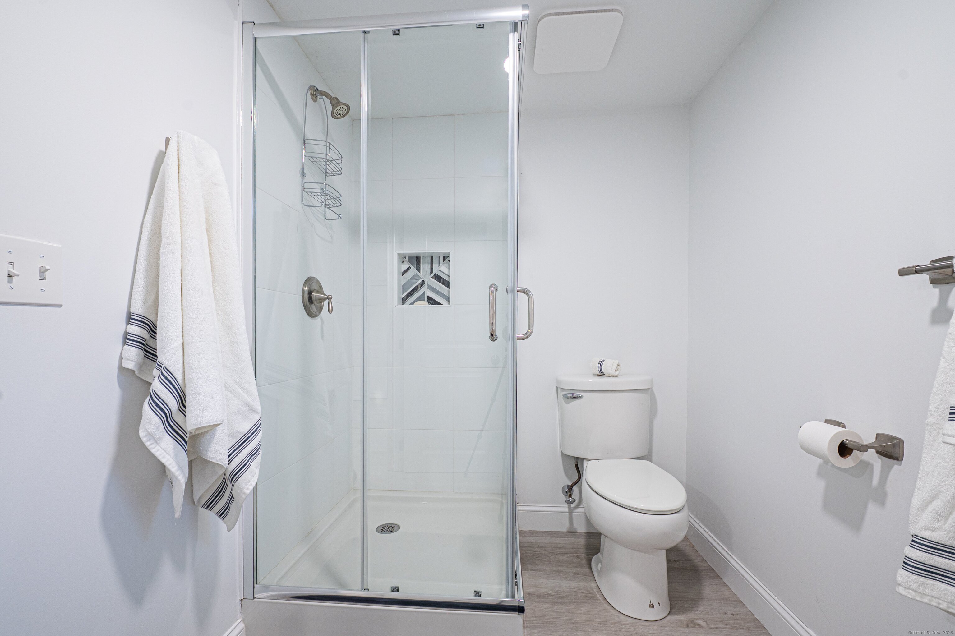 15 Griffing Pond Road Branford, CT 06405 - Photo 40 of 40 a white toilet sitting next to a bathroom sink