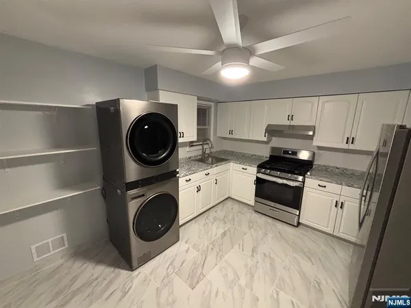 a kitchen with a stove a microwave and cabinets