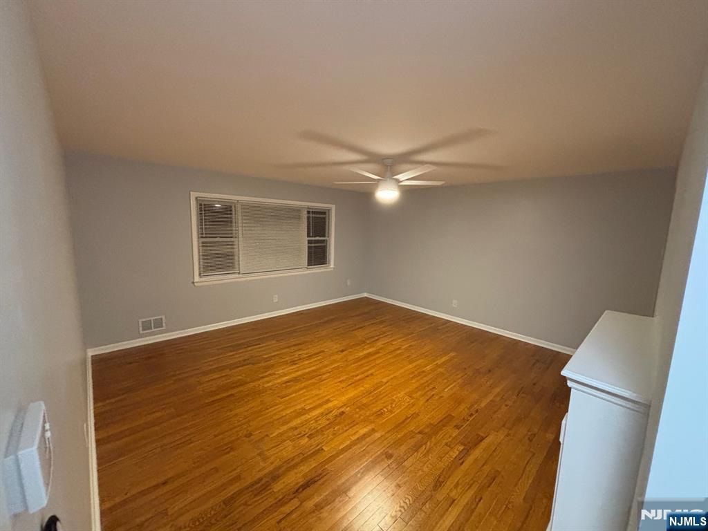 47 Cooper Street Bergenfield, NJ 07621 - Photo 6 of 12 a view of an empty room with a window