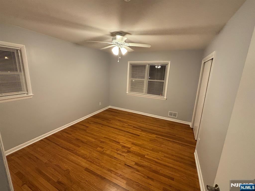 47 Cooper Street Bergenfield, NJ 07621 - Photo 8 of 12 a view of empty room with wooden floor and fan