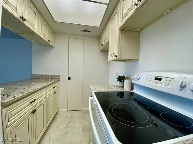 a kitchen with sink stove and cabinets