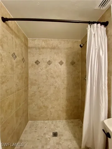 a bathroom with a shower and a tub