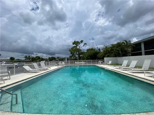 a view of a swimming pool with a yard