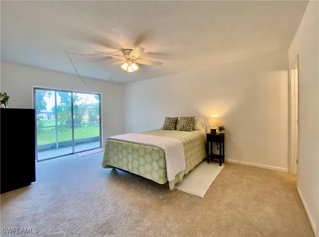 a spacious bedroom with a bed and a chandelier