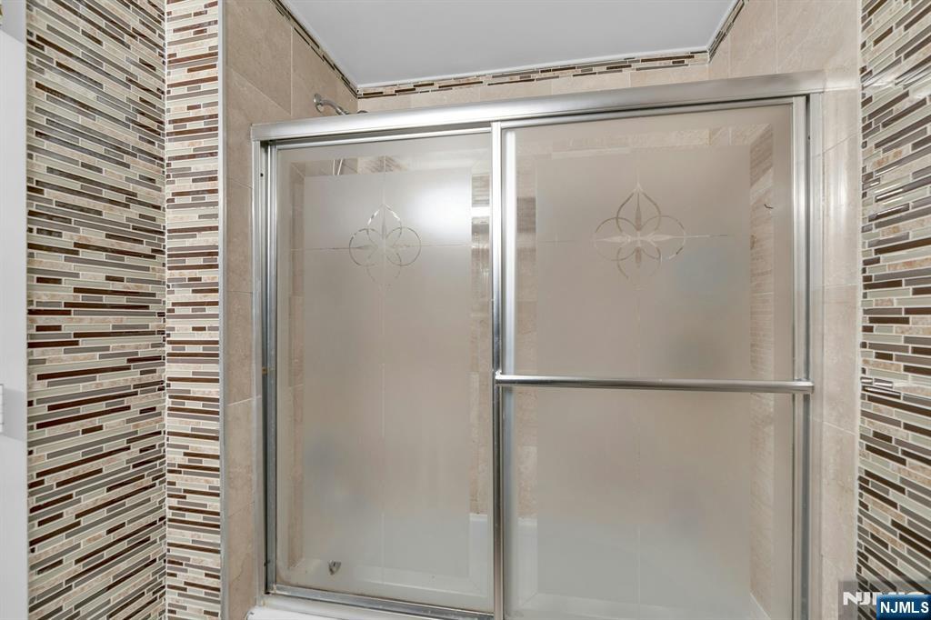 100 Old Palisade Road, Unit 3101 Fort Lee, NJ 07024 - Photo 15 of 28 a bathroom with a glass shower door