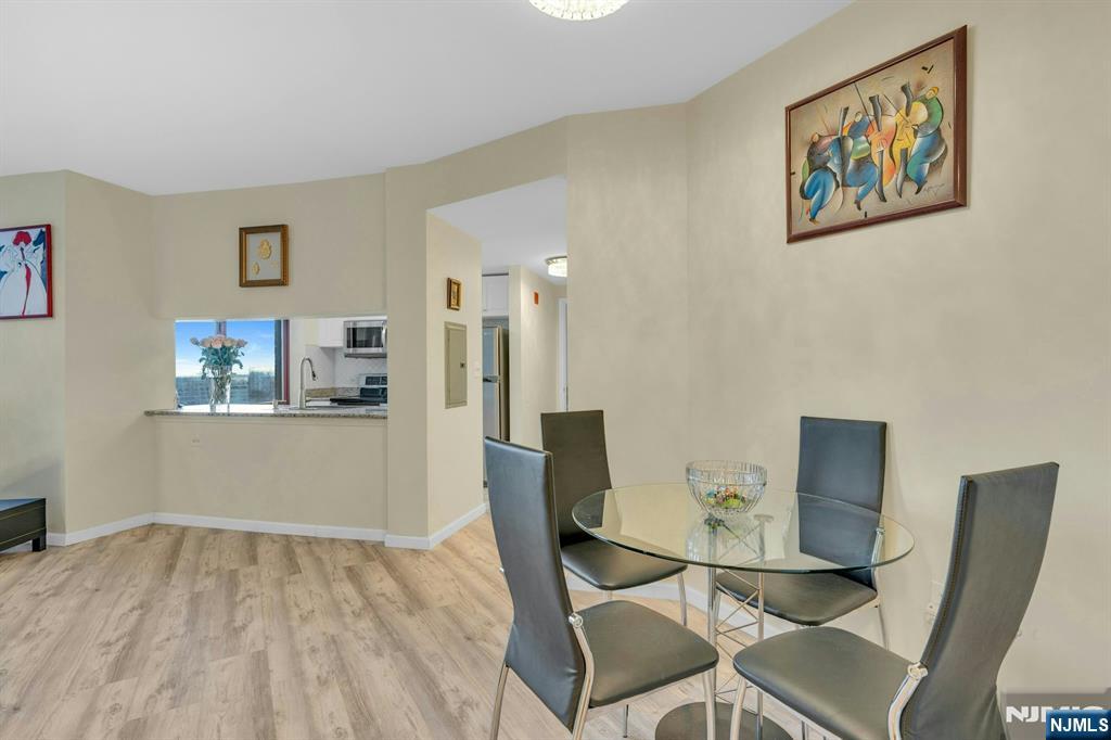 100 Old Palisade Road, Unit 3101 Fort Lee, NJ 07024 - Photo 7 of 28 a view of a dining room with furniture and wooden floor