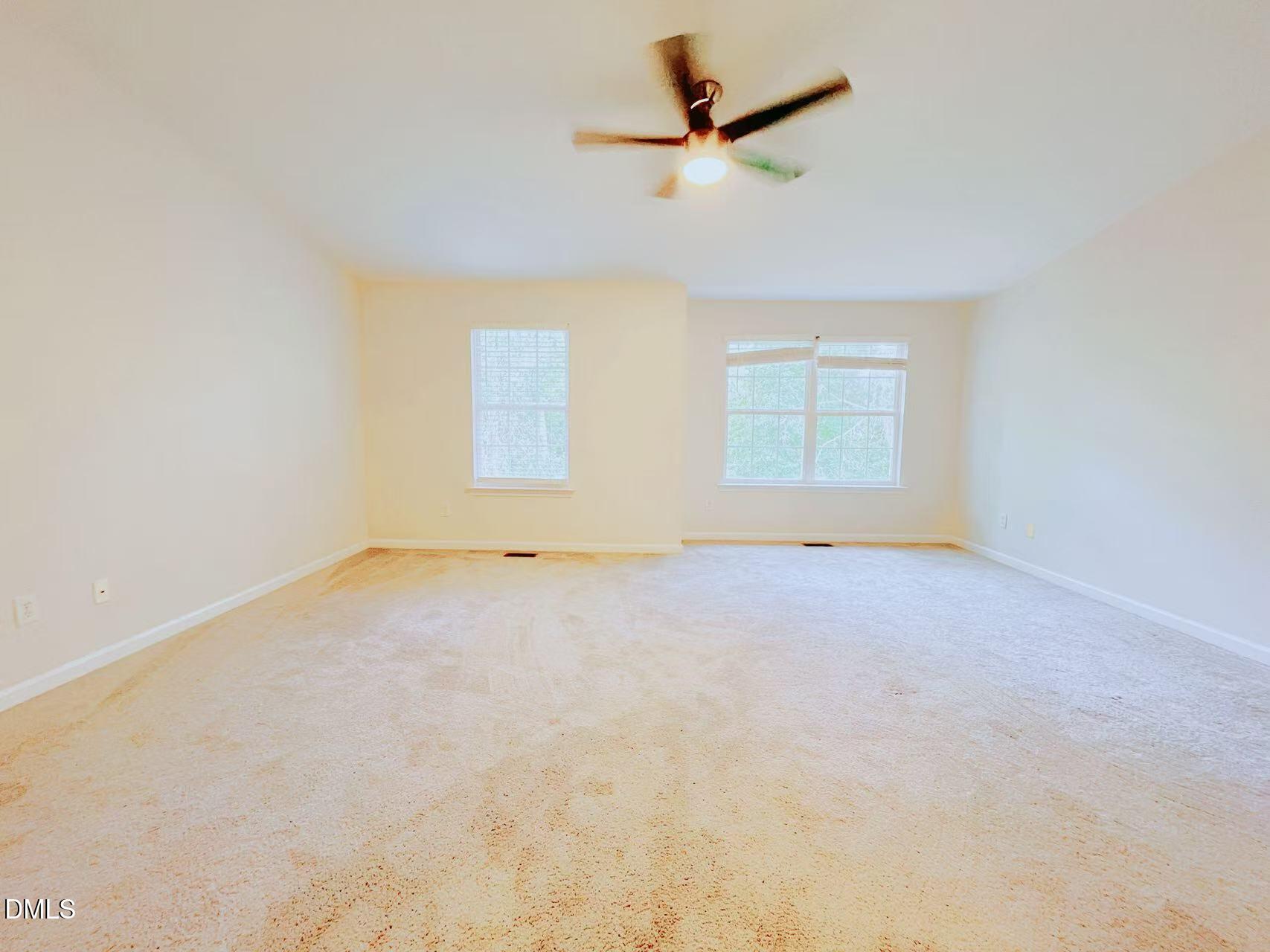 3040 Barrymore Street, Unit 108 Raleigh, NC 27603 - Photo 11 of 13 an empty room with a empty space and a ceiling fan