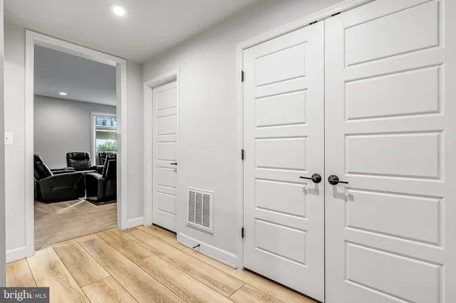 a bedroom with a bed and a refrigerator