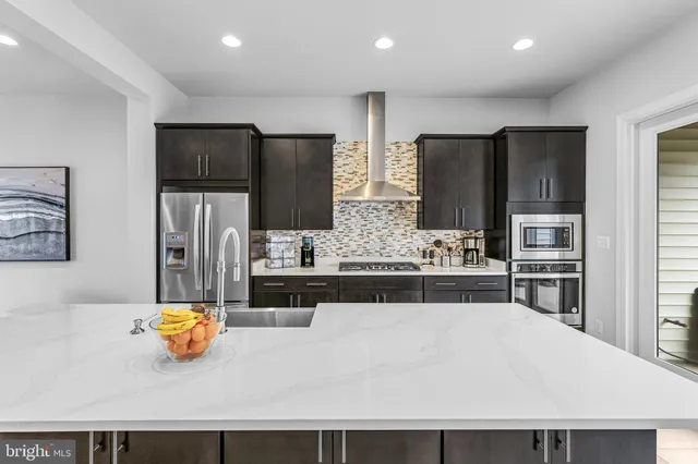 a kitchen with stainless steel appliances a refrigerator and a sink