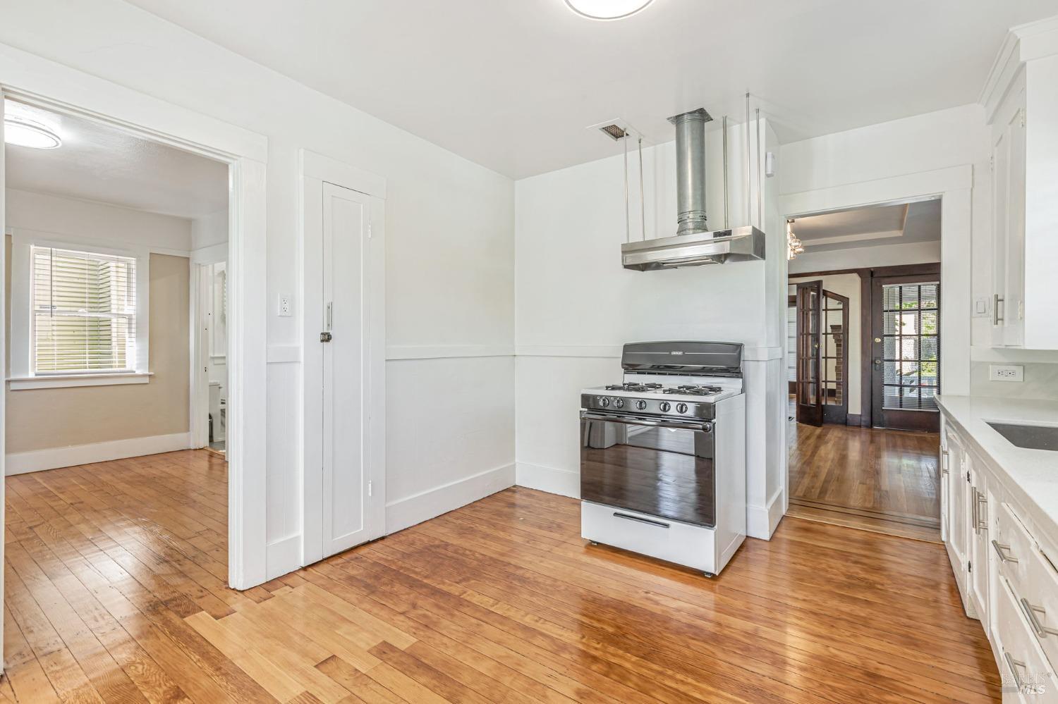 1528 Sutter Street Vallejo, CA 94590 - Photo 16 of 33 a kitchen with stainless steel appliances a stove and wooden floor