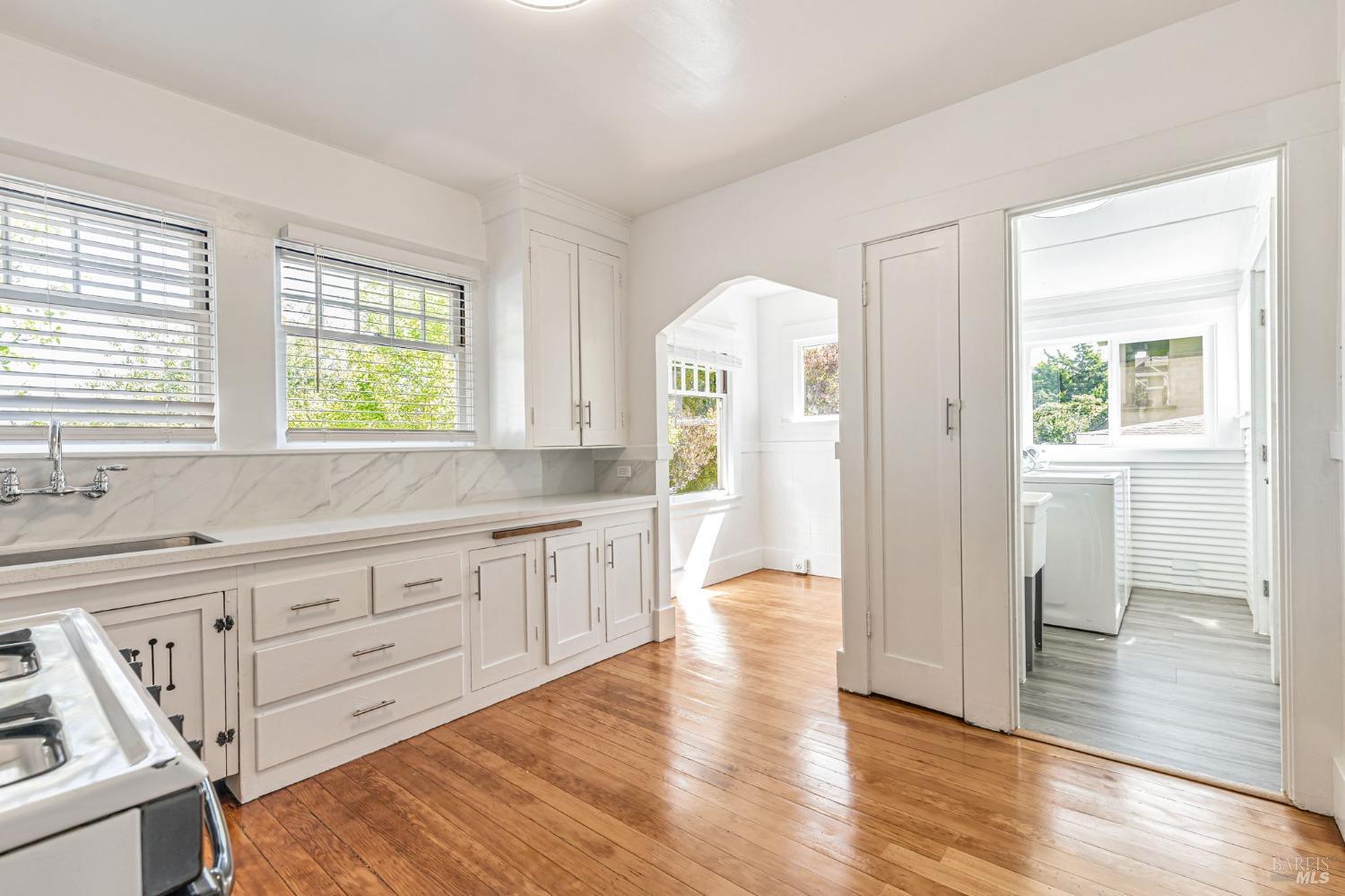 1528 Sutter Street Vallejo, CA 94590 - Photo 18 of 33 a view of a kitchen and entryway with wooden floors