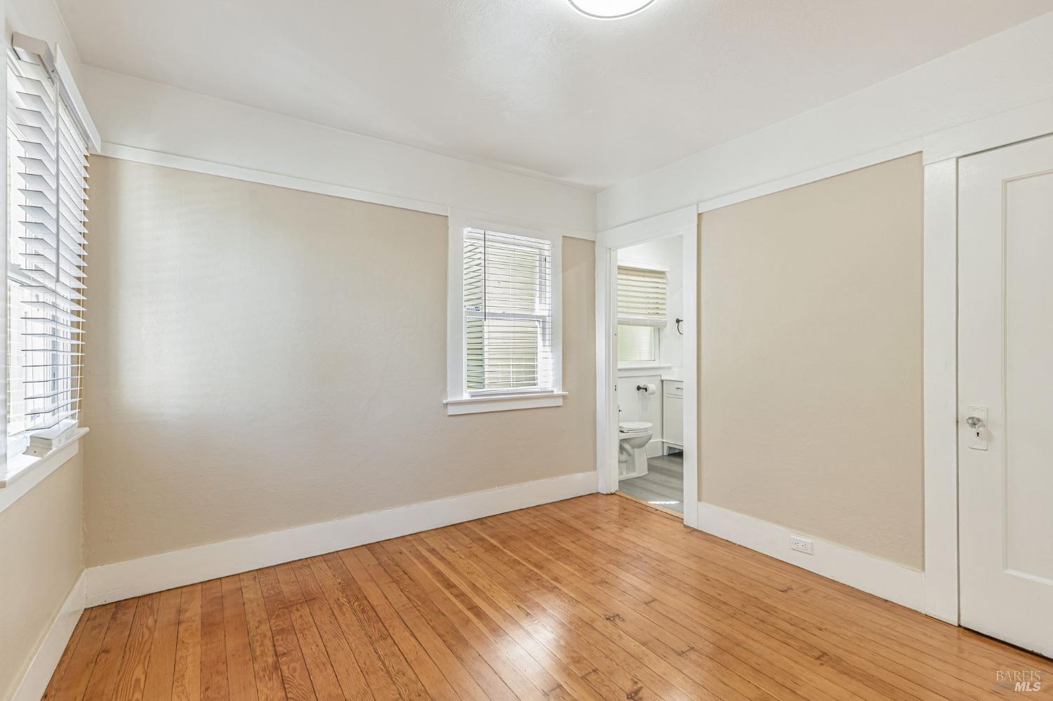 1528 Sutter Street Vallejo, CA 94590 - Photo 22 of 33 a view of empty room with wooden floor and fan