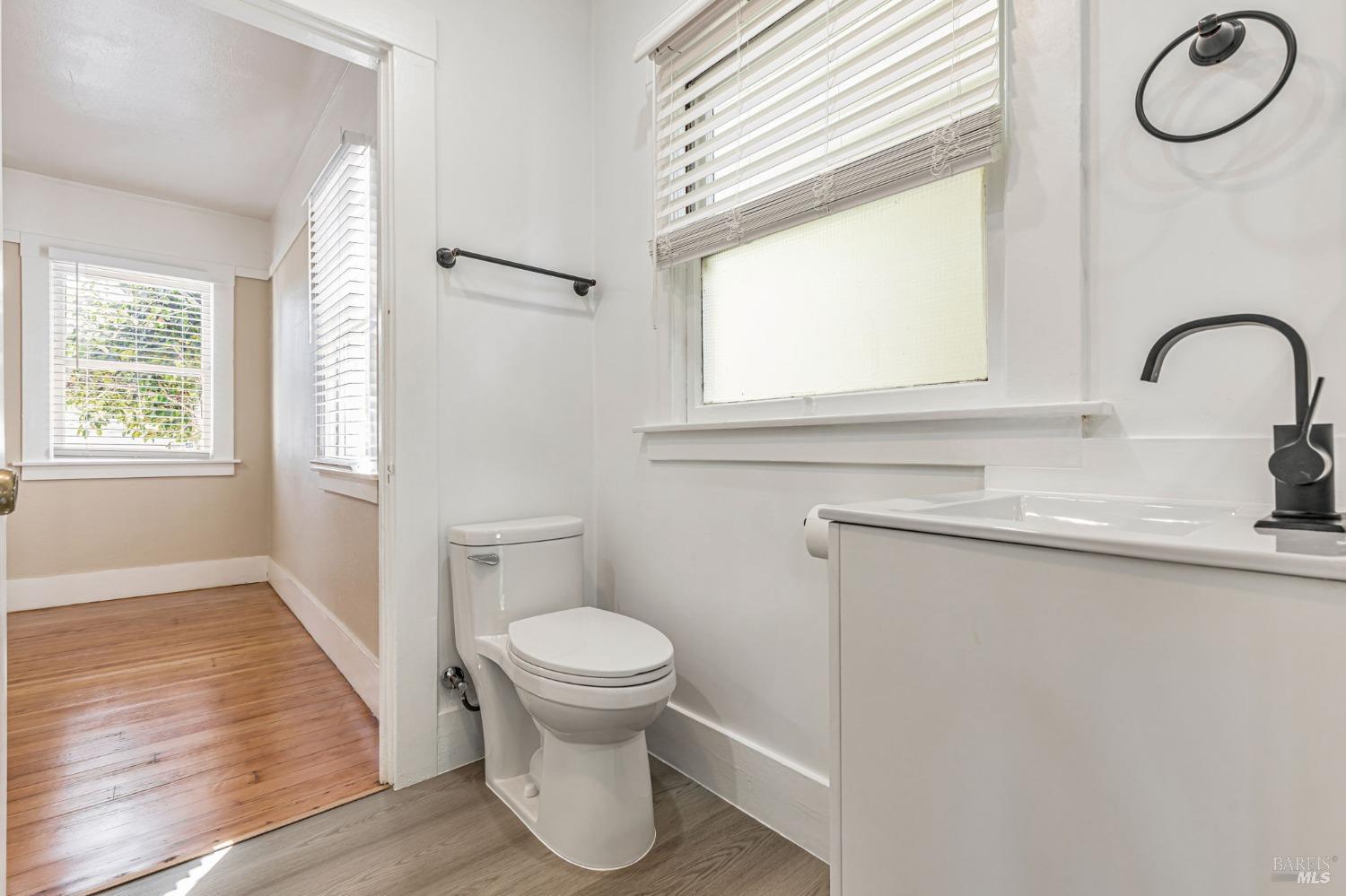 1528 Sutter Street Vallejo, CA 94590 - Photo 24 of 33 a bathroom with a toilet a sink and a window