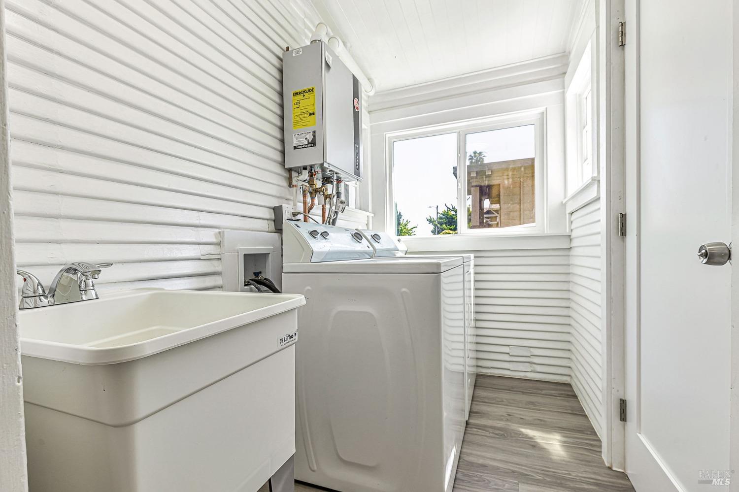 1528 Sutter Street Vallejo, CA 94590 - Photo 26 of 33 a bathroom with a sink a window and a mirror