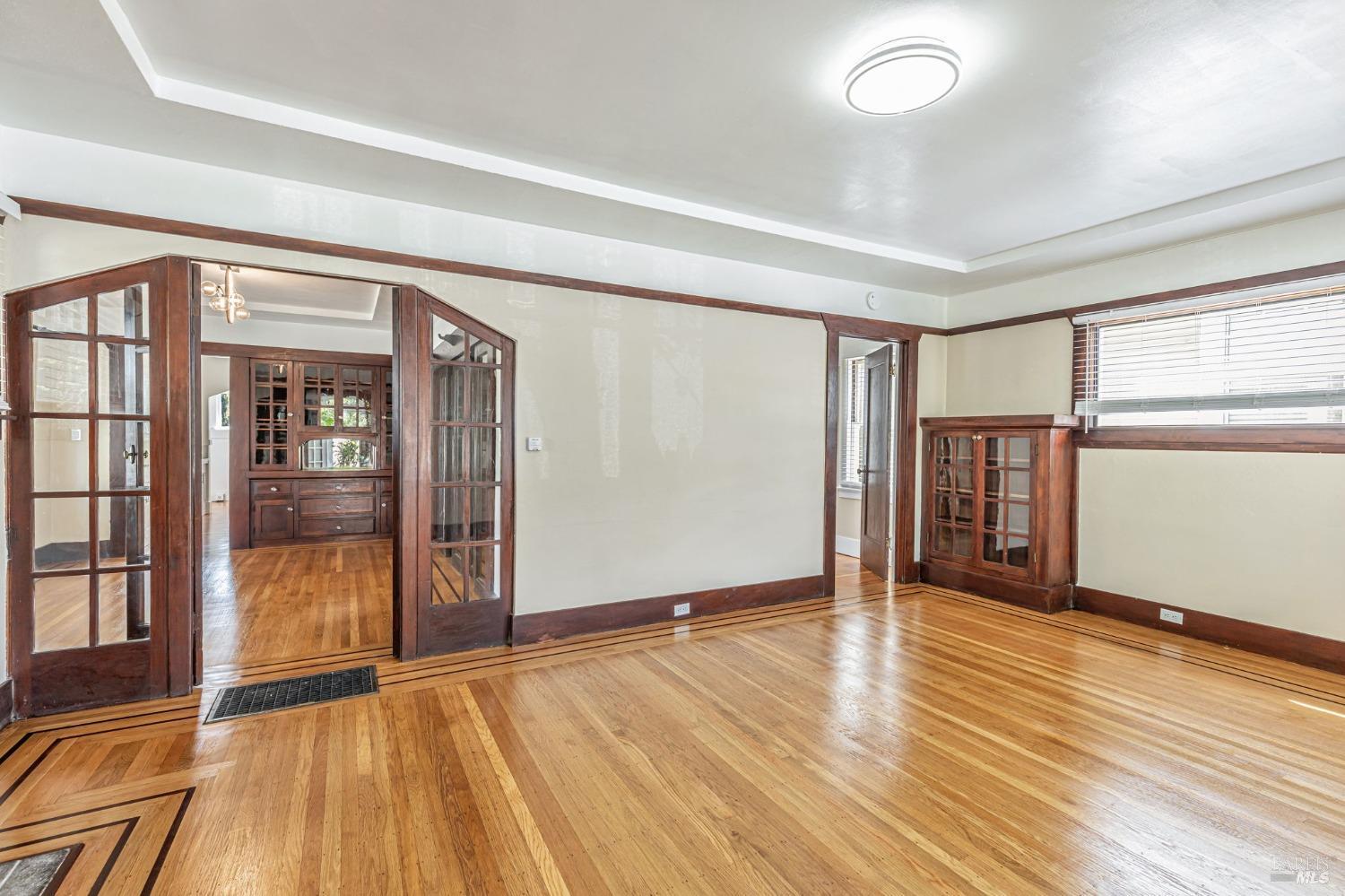 1528 Sutter Street Vallejo, CA 94590 - Photo 5 of 33 wooden floor in an empty room with a window