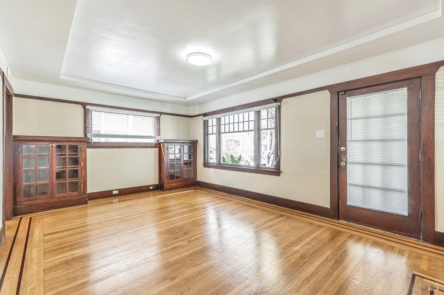 1528 Sutter Street Vallejo, CA 94590 - Photo 7 of 33 an empty room with wooden floor and windows
