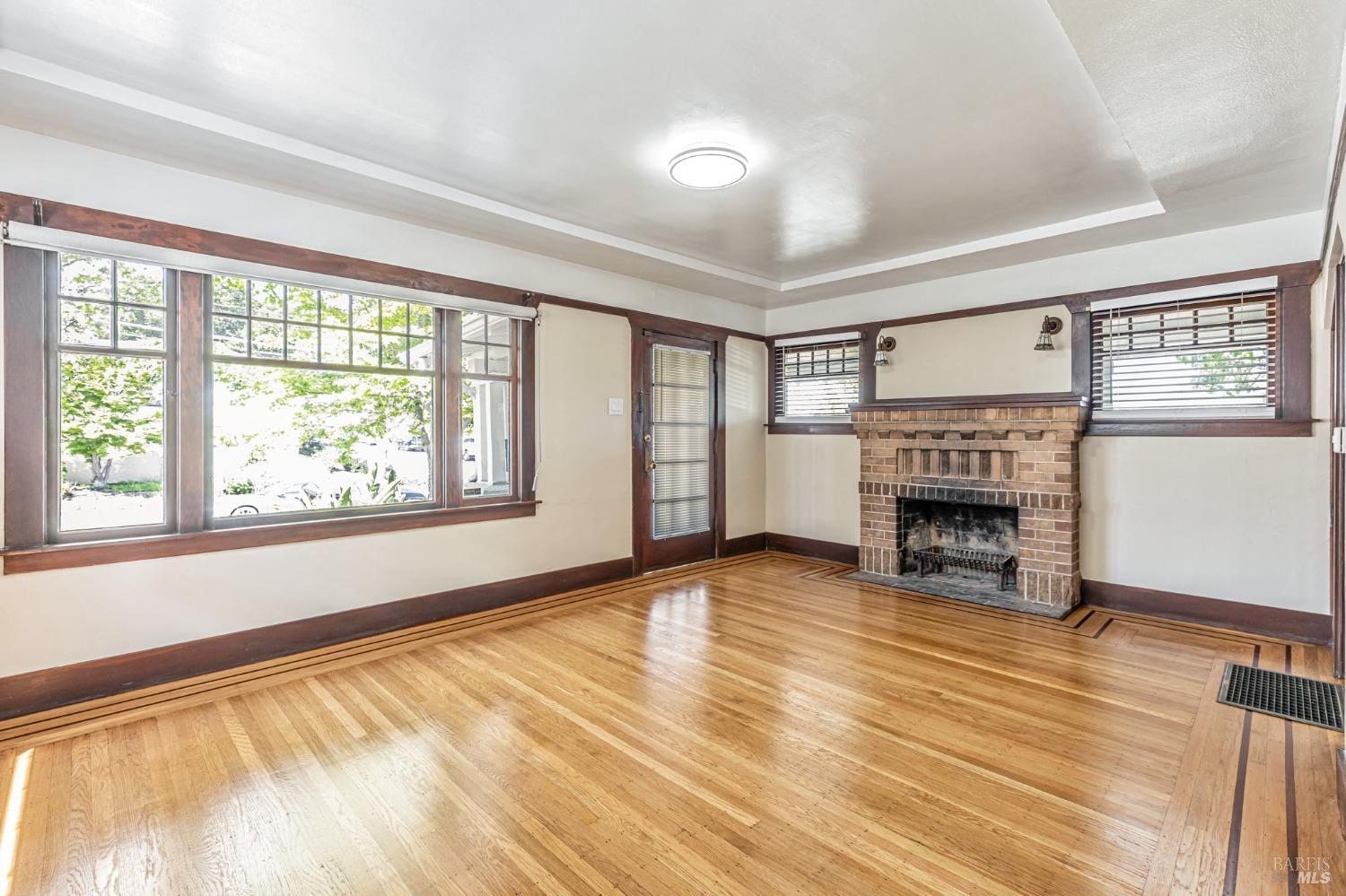 1528 Sutter Street Vallejo, CA 94590 - Photo 8 of 33 wooden floor fireplace and windows in an empty room