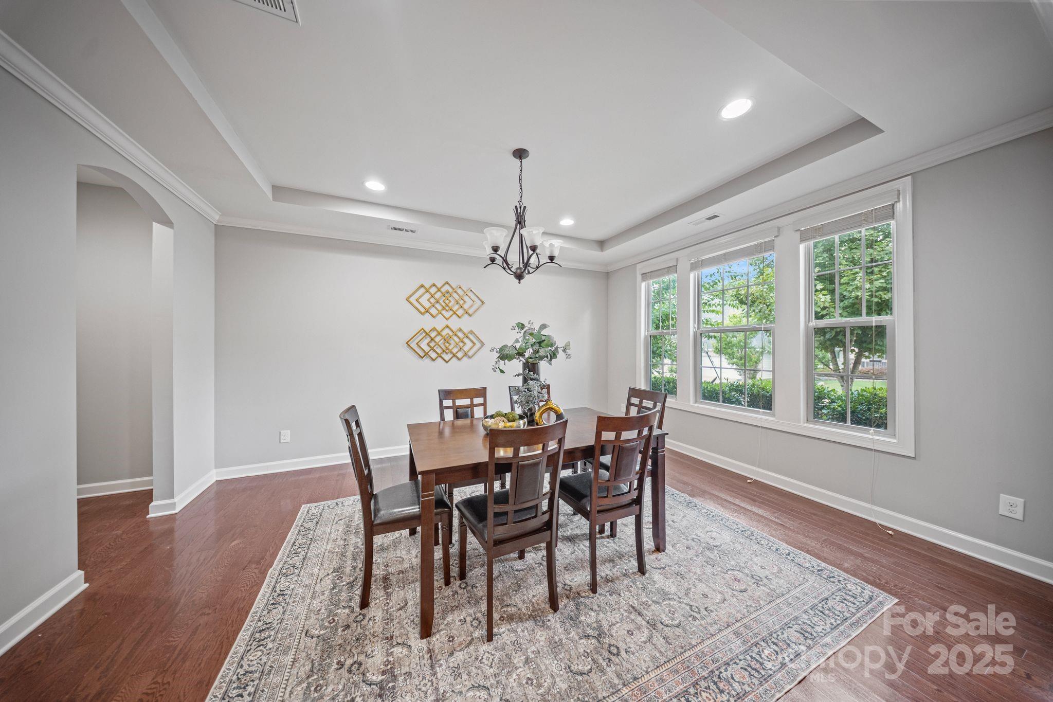 1433 Cilantro Court Tega Cay, SC 29708 - Photo 15 of 42 a view of a dining room with furniture window and wooden floor