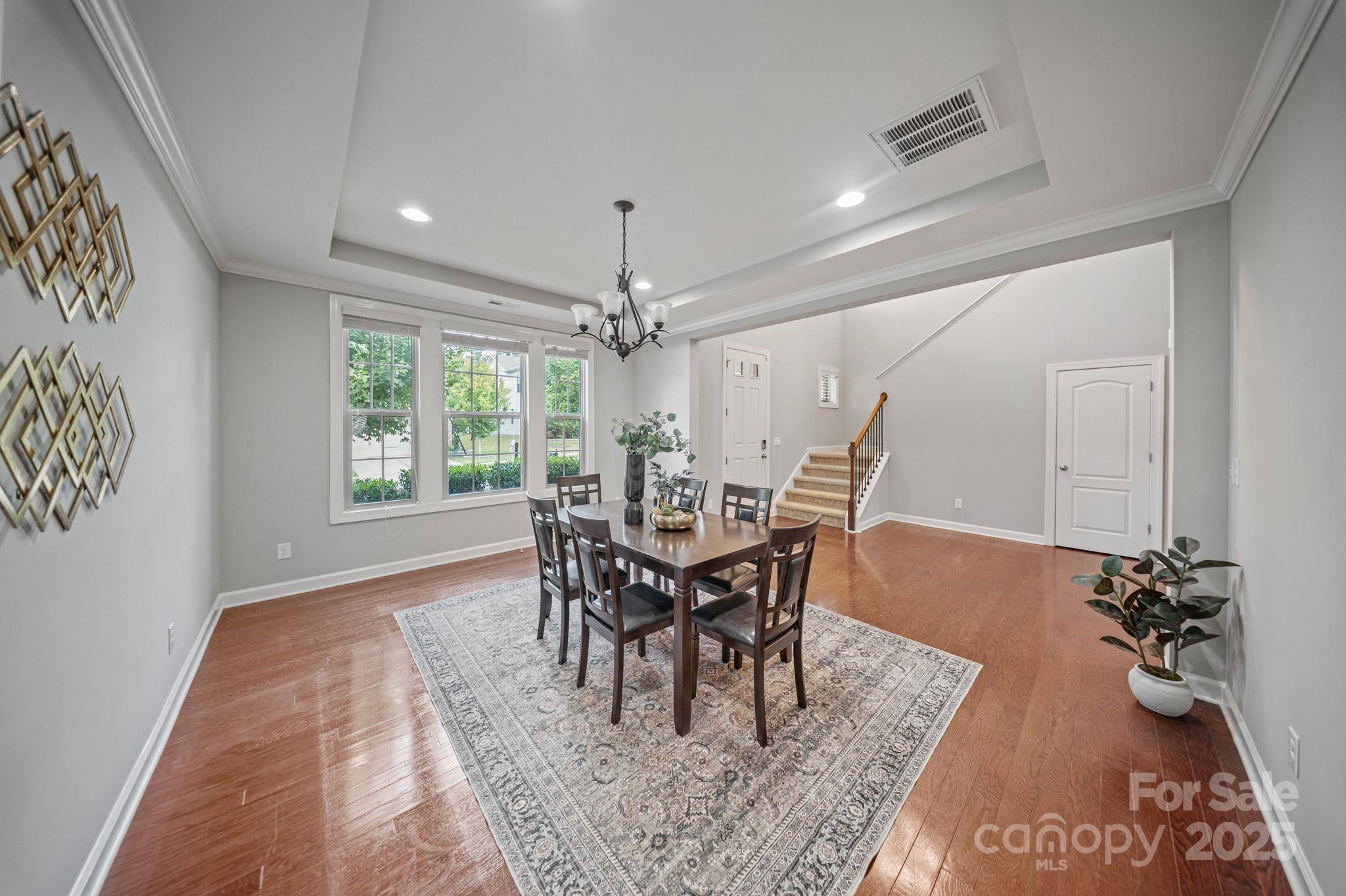 1433 Cilantro Court Tega Cay, SC 29708 - Photo 16 of 42 a view of a dining room with furniture and a chandelier