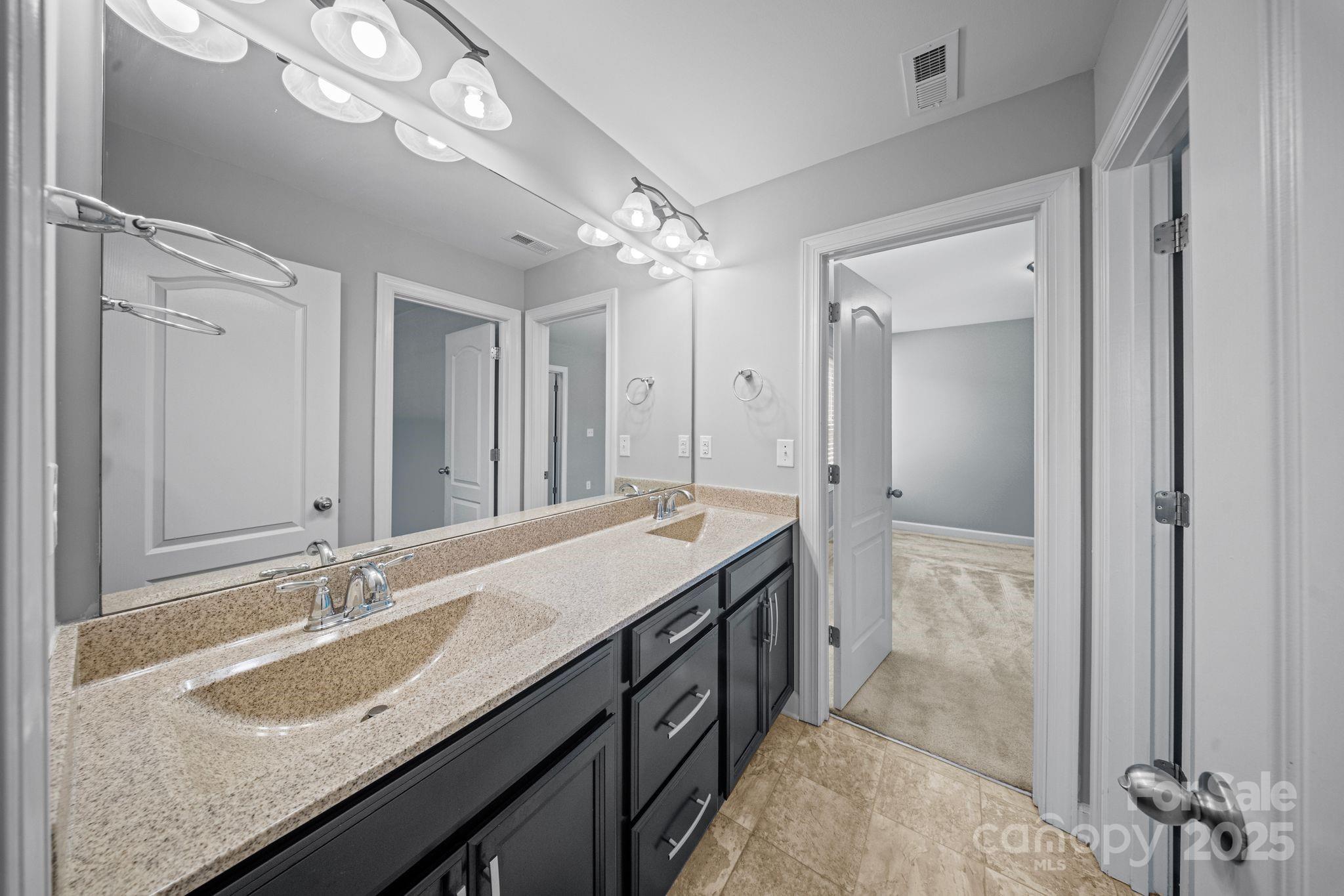 1433 Cilantro Court Tega Cay, SC 29708 - Photo 23 of 42 a bathroom with a sink double vanity and a mirror