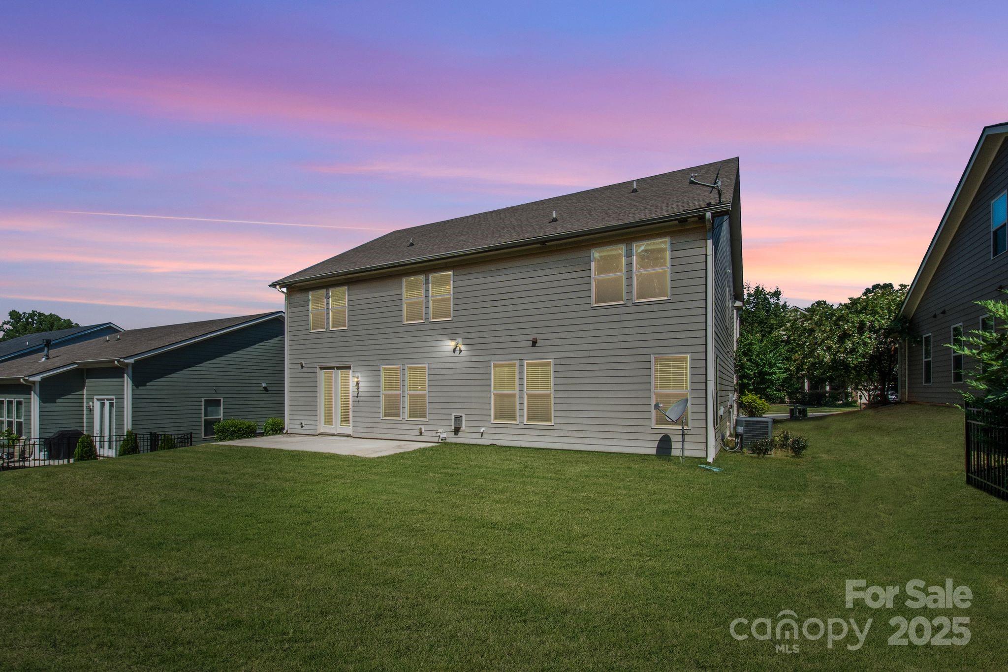 1433 Cilantro Court Tega Cay, SC 29708 - Photo 3 of 42 a front view of a house with a yard porch and outdoor seating