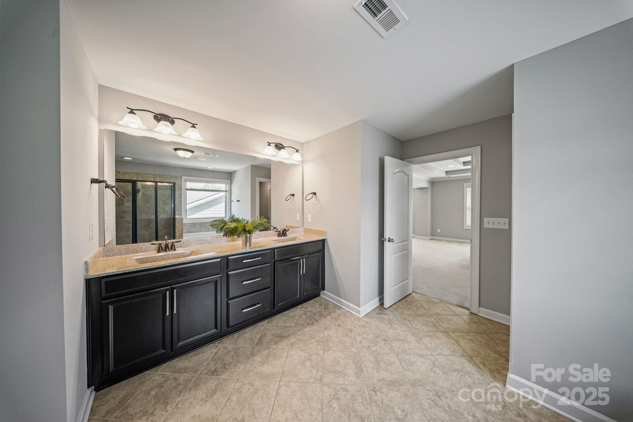 1433 Cilantro Court Tega Cay, SC 29708 - Photo 40 of 42 a large bathroom with a sink and a mirror