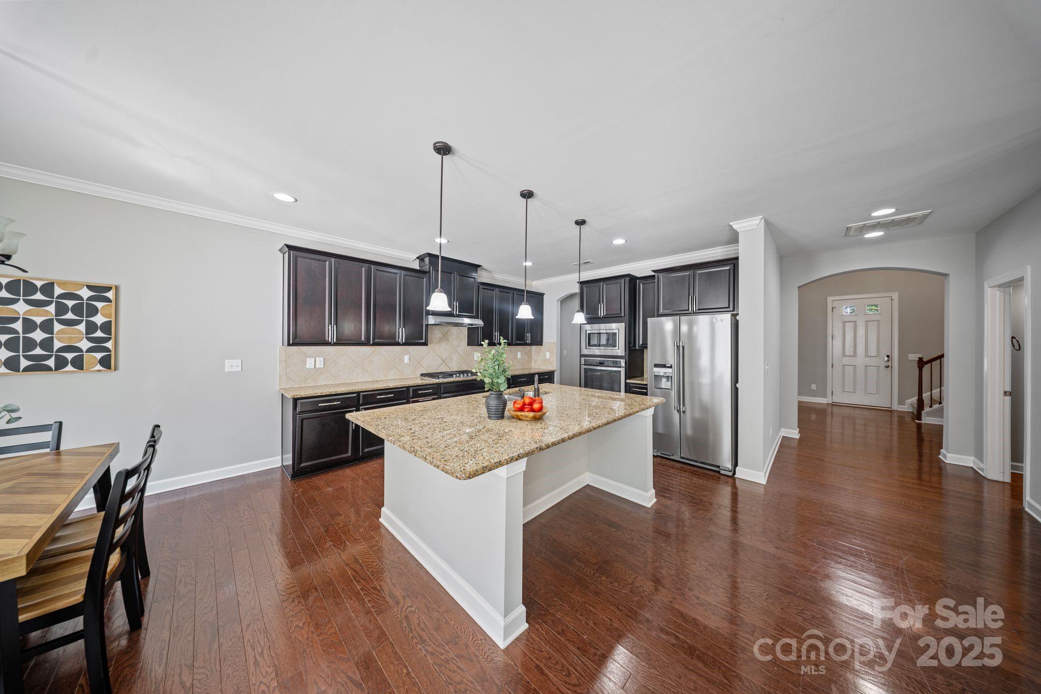 1433 Cilantro Court Tega Cay, SC 29708 - Photo 5 of 42 a open kitchen with stainless steel appliances granite countertop a stove and a refrigerator
