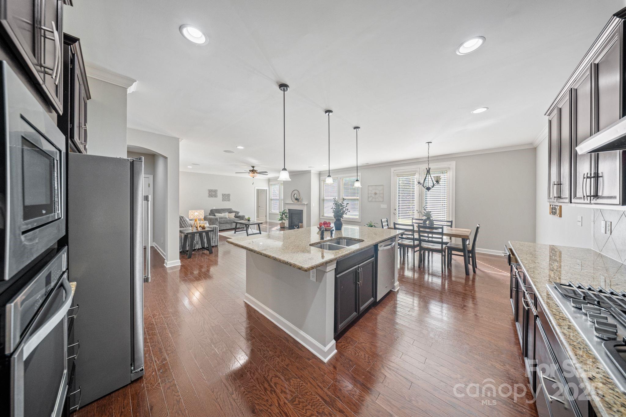 1433 Cilantro Court Tega Cay, SC 29708 - Photo 8 of 42 a kitchen with stainless steel appliances granite countertop a stove oven and a refrigerator