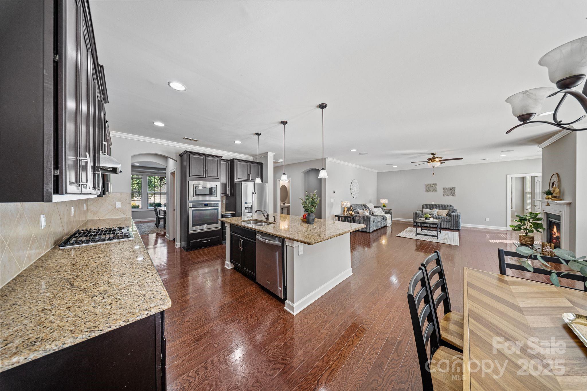 1433 Cilantro Court Tega Cay, SC 29708 - Photo 9 of 42 a large white kitchen with lots of counter top space and stainless steel appliances