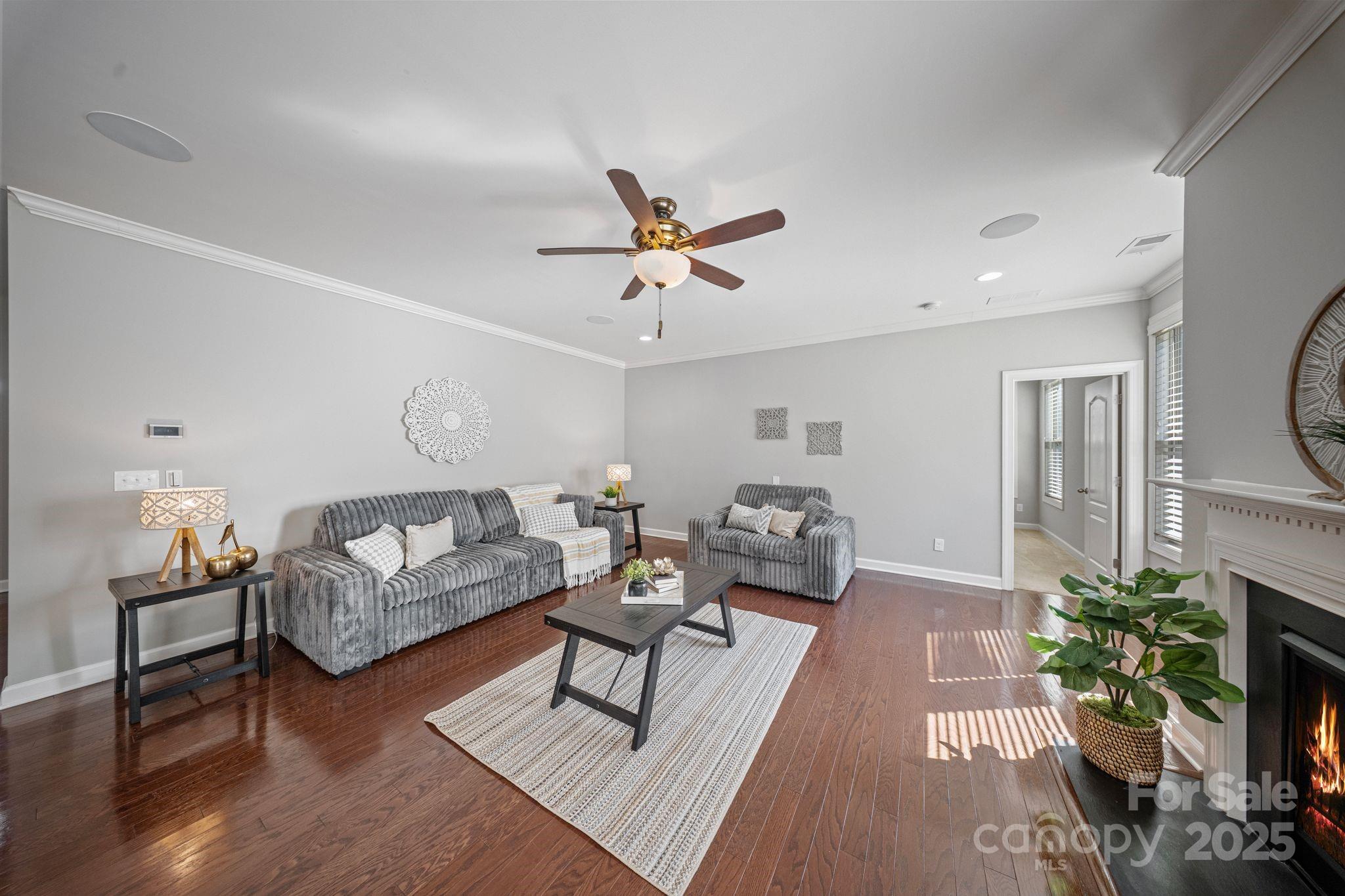 1433 Cilantro Court Tega Cay, SC 29708 - Photo 10 of 42 a living room with furniture and a chandelier