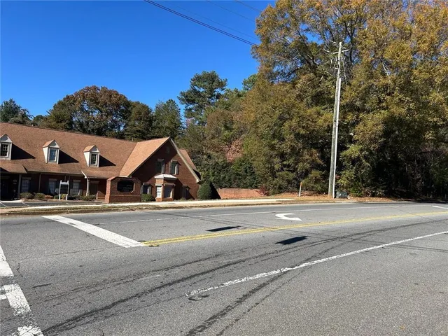 front view of house with a yard and balcony