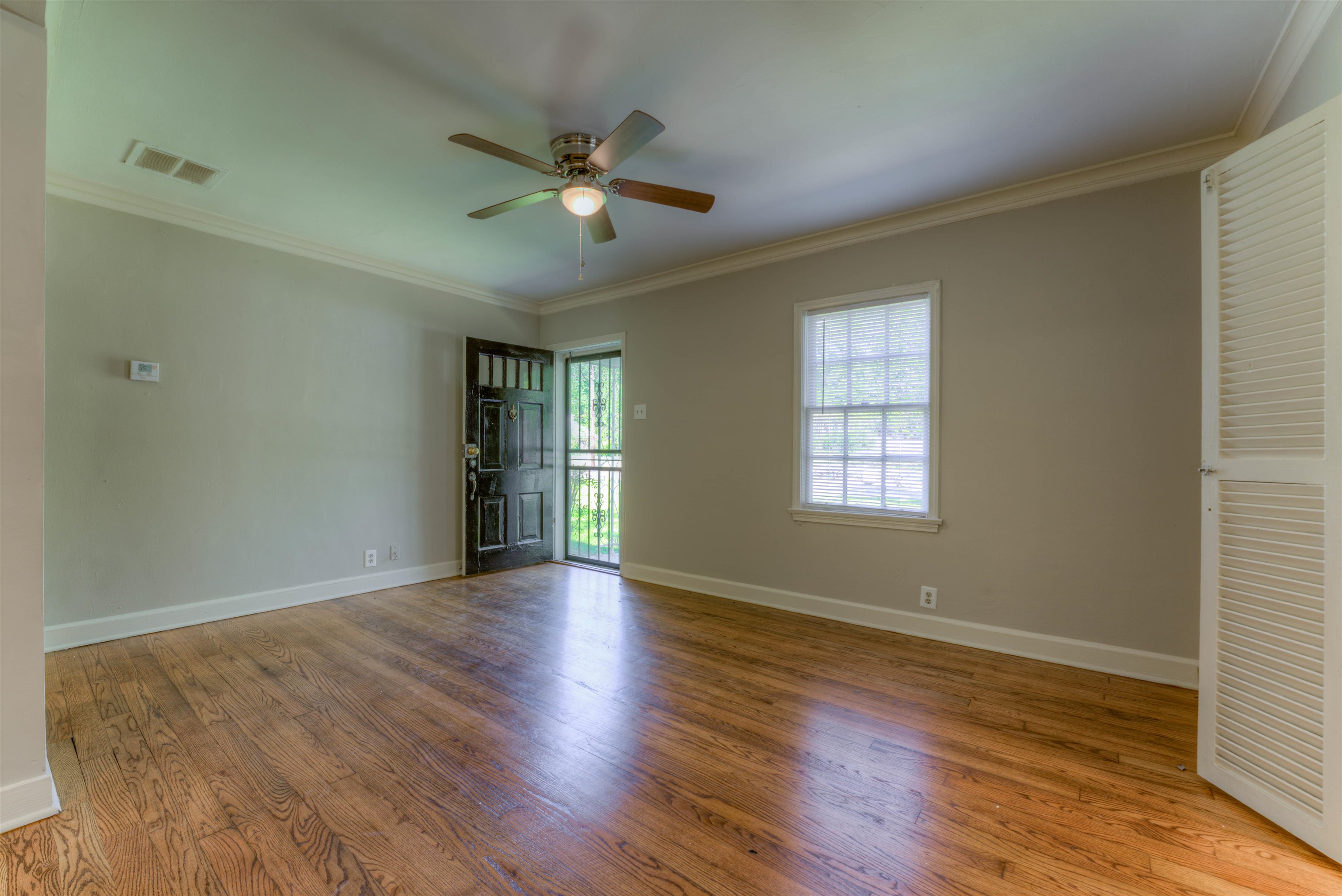 777 Loeb Street Memphis, TN 38111 - Photo 11 of 22 a view of an empty room with wooden floor and a window