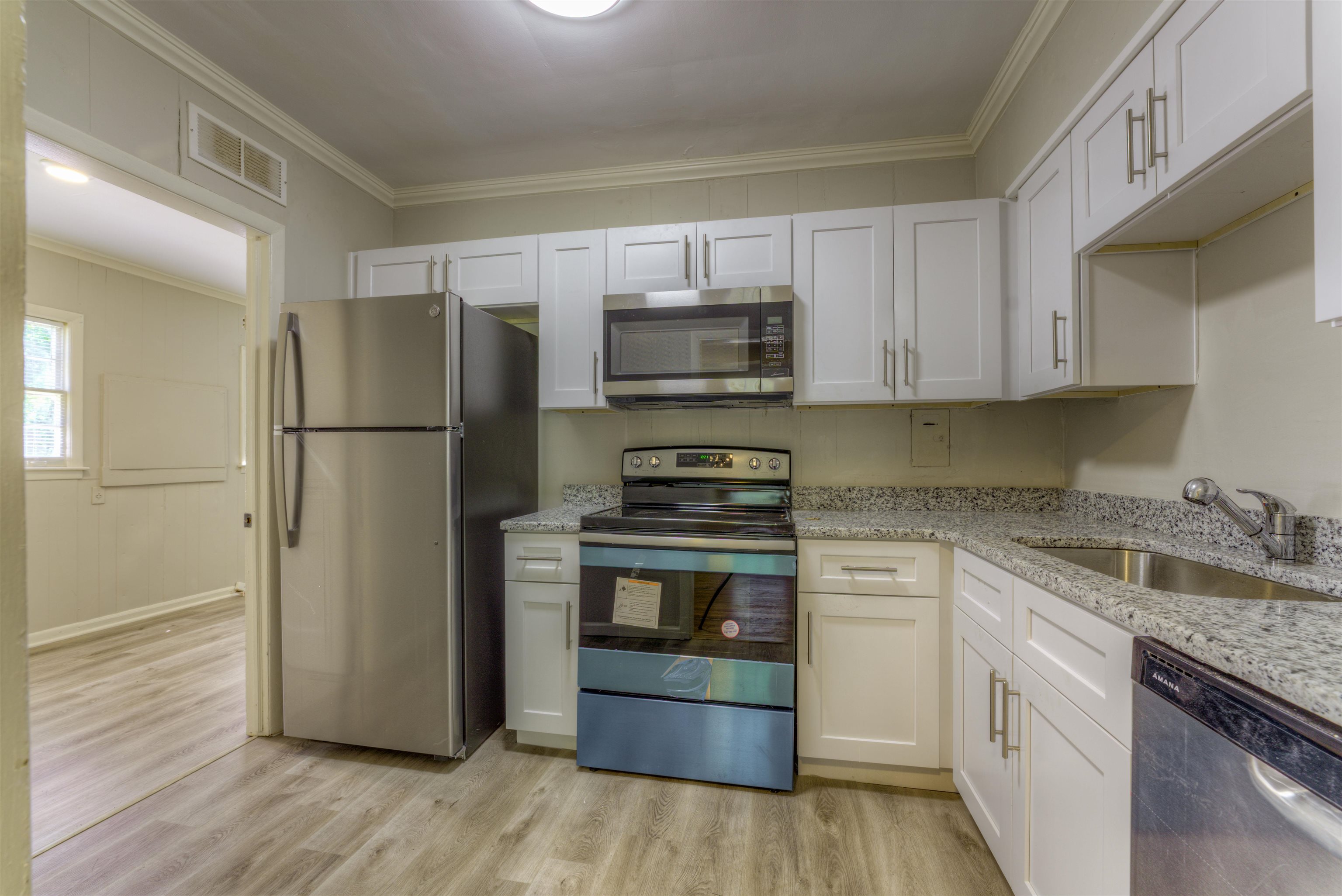 777 Loeb Street Memphis, TN 38111 - Photo 14 of 22 a kitchen with a refrigerator stove and wooden cabinets