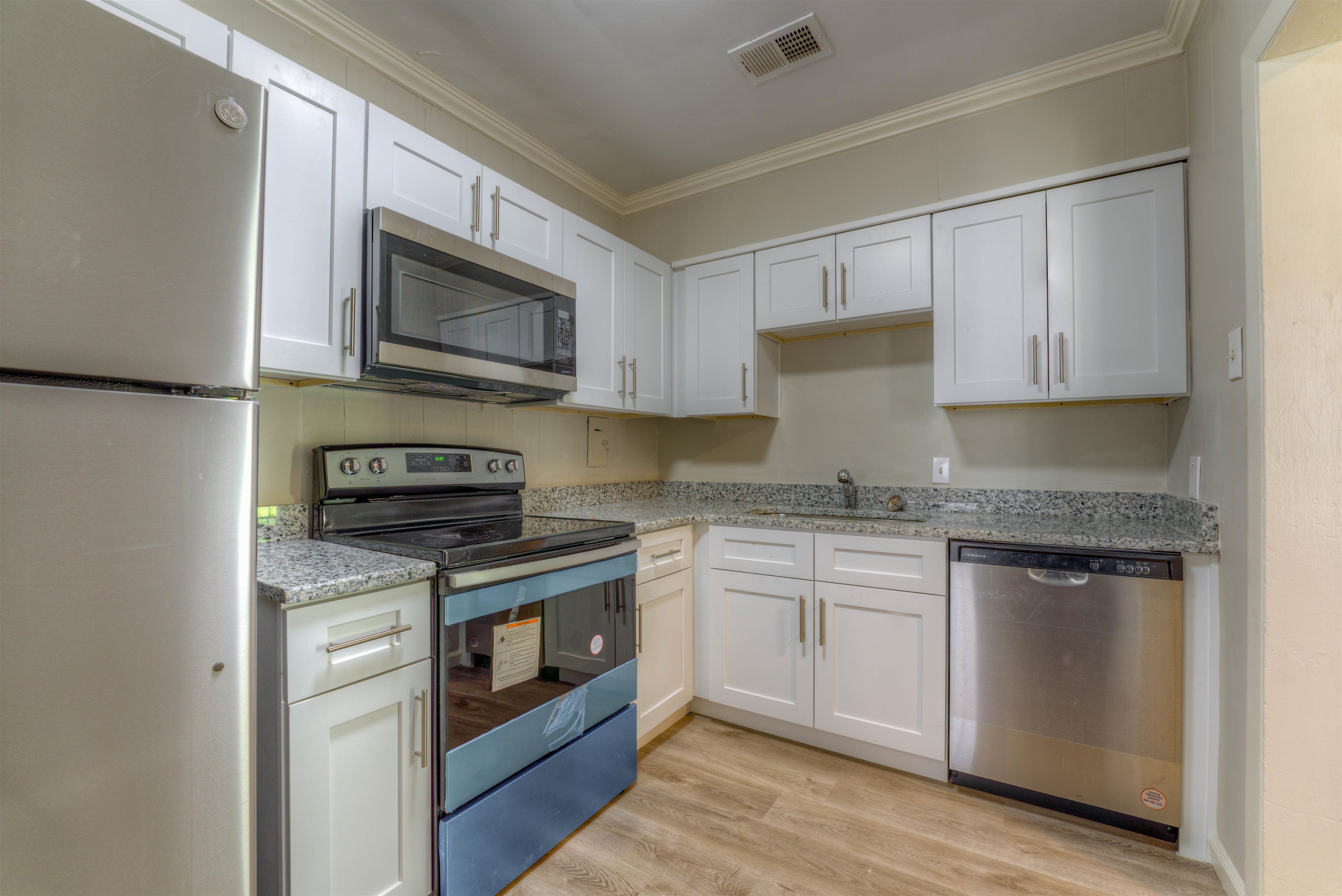 777 Loeb Street Memphis, TN 38111 - Photo 15 of 22 a kitchen with stainless steel appliances granite countertop a stove top oven microwave and cabinets
